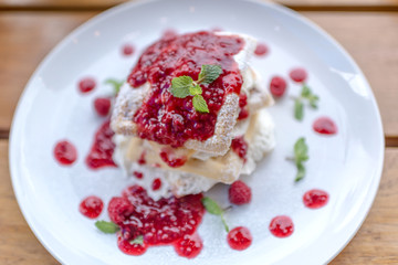 waffle with strawberry on wooden table, selective focus.