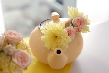 Bouquet of beautiful flowers in pot  on a yellow napkin