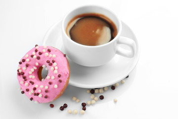 Delicious donut with cup of coffee isolated on white