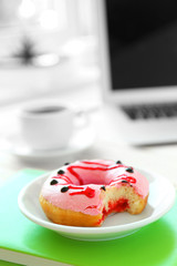 Delicious donuts on green notebook closeup