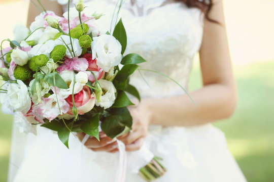Bride with flower bouquet on her wedding day