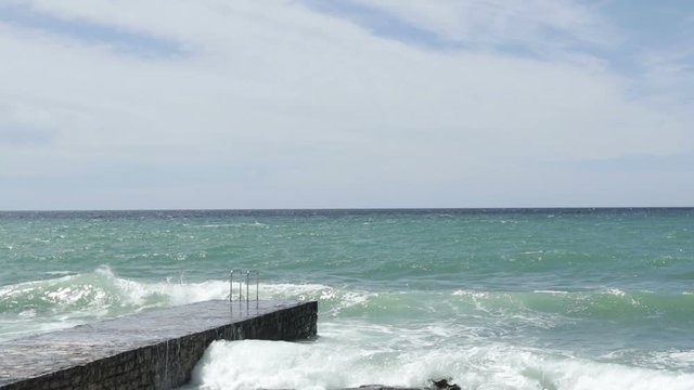 big sea wave splashing against a pier in Novigrad. Istria. Croatia.