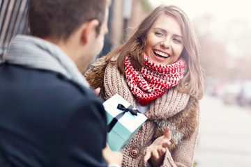 Young couple with present in the park