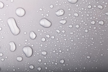 Drops of water on a color background. Gray
