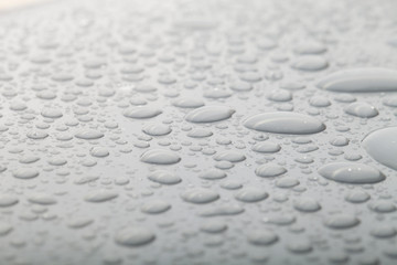 Drops of water on a color background. Gray. Shallow depth of fie