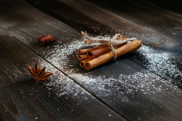 Fresh cinnamon sticks on the black wooden table