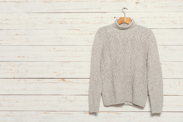 knitted sweater on wooden clothes rack