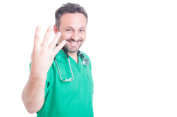 Smiling man doctor counting four fingers