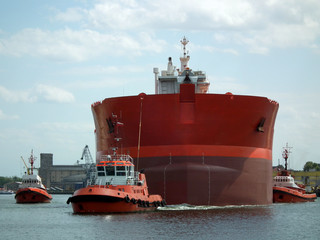 Tugboats pilot ship