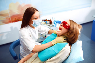 funny moment. doctor smothers her patient .Professional woman dentist doctor working . woman at...