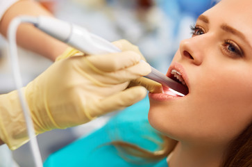 Overview of dental caries prevention.Woman at the dentist's chair during a dental procedure. Beautiful Woman smile close up. Healthy Smile. Beautiful Female Smile