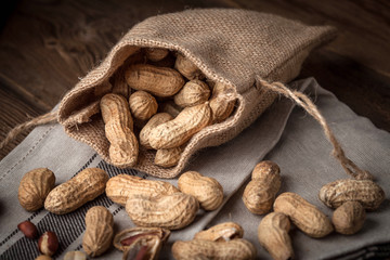 Dried peanuts in wooden bowl.
