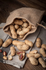 Dried peanuts in wooden bowl.