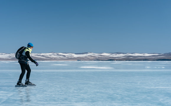 Tourists travel to Norway hiking ice skating on the frozen lake. Special long skate for long distances. Mounting under the ski boots. Location of Lake Baikal action. The Russian called Bayes or Loft.