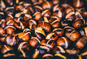 Roasting grilled Chestnuts on barbecue with flames, fire and cha