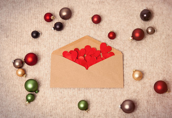 Naklejka na ściany i meble Christmas envelope with hearts and baubles