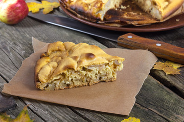 piece of apple pie on a wooden table in autumn style