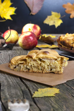piece of apple pie on a wooden table in autumn style