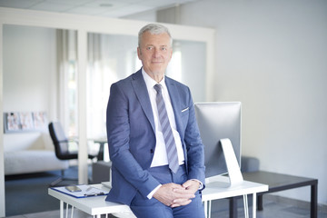 Naklejka premium Professional man. Shot of an executive senior businessman sitting at office.