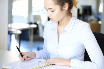 Fill the form. Close-up shot of a businesswoman using fountain pen while sitting at desk and fill...