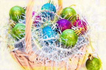 Christmas balls on tinsel in basket. Blurred photo for background