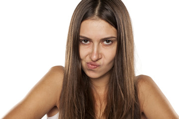 Fototapeta premium young angry woman looking with distrust at camera