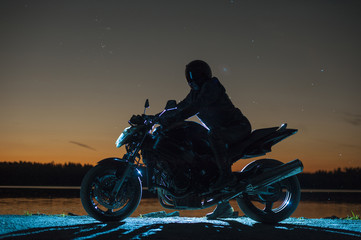Male biker sitting on motorbike