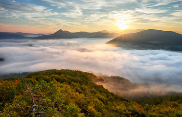 Autumn sunrise above mist and forest landscape, Slovakia, Nosice