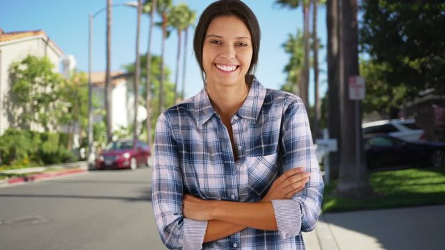 Young white girl standing in a California suburban neighborhood. Millennial Caucasian woman posing for a portrait in a family neighborhood