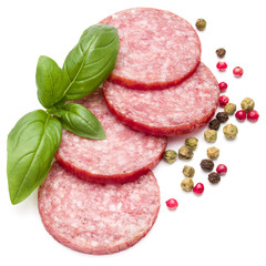 Salami smoked sausage slices, basil leaves and peppercorns isola
