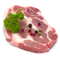 Raw pork neck chop meat with parsley herb leaves and peppercorn
