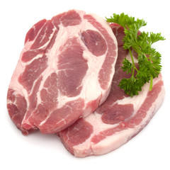 Raw pork neck chop meat with parsley herb leaves garnish isolate