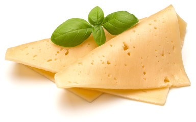 cheese slices and basil herb leaves isolated on white background