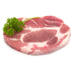 Raw pork neck chop meat with parsley herb leaves garnish isolate