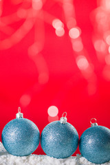 Christmas ball on snow and silver glitter background