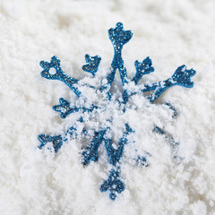 Christmas snowflake bauble decoration on snow.