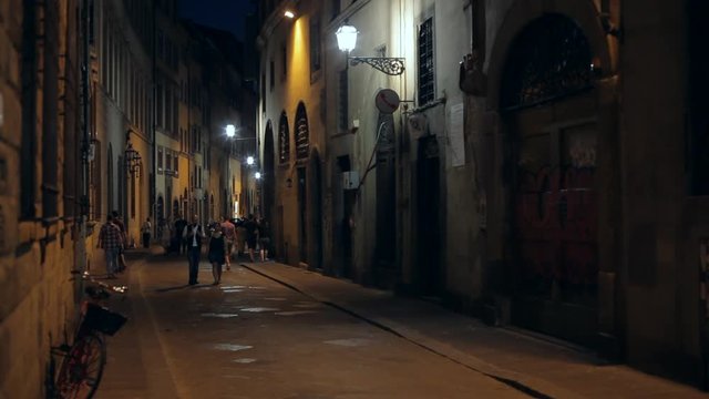WS LD People Walking down Narrow Street at Night / Florence, Italy