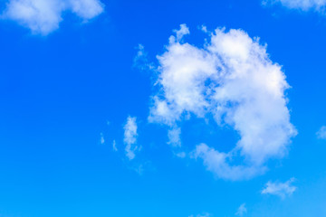 Blue sky background with white clouds. The vast blue sky and clouds sky on sunny day. White fluffy clouds in the blue sky.