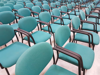 Row of chairs inside a congress room.
