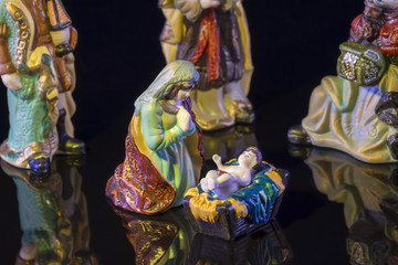 Christmas scene with Jesus and Mary on black background. Focus on Mary!