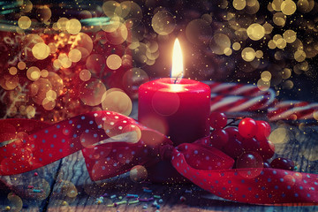 Red burning candle with ribbon, Christmas or New Year's backgrou