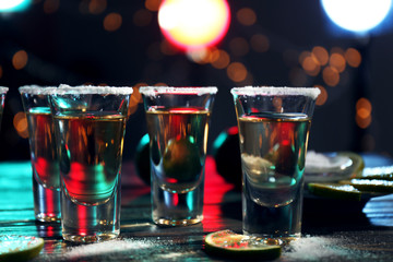 Gold tequila shots with lime and salt in bar