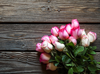 Pink roses bouquet over wooden table. Top view with copy space. flowers