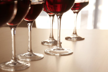 Glasses of red wine on table in restaurant