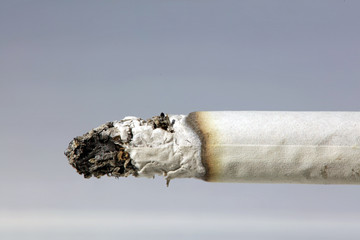 Anti smoking, stop quit smoking concept. Close up on smoking cigarette.