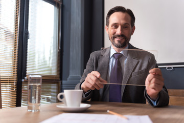 Cheerful successful businessman holding a the tablet