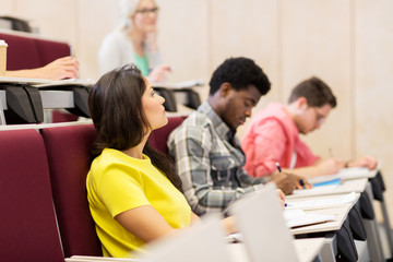 group of students with notebooks in lecture hall