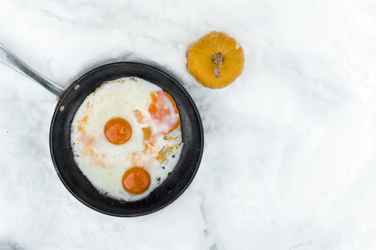 Frying Eggs On Snow