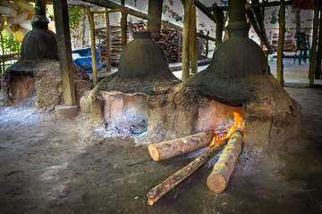 arak fabrication on flores, indonesia by destillation of palm juice in a unique pot still