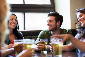 happy friends drinking beer at bar or pub